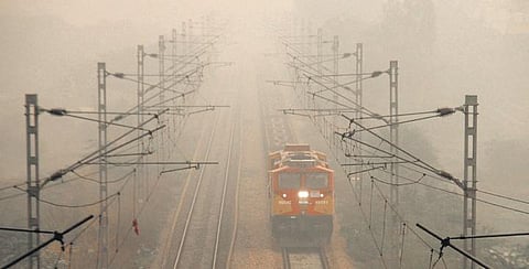 A train runs amid low visibility due to smog in Gurugram on Thursday. (Photo | PTI)