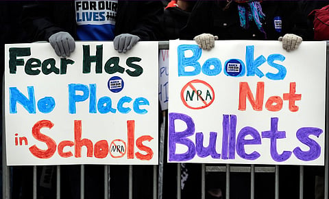 Demonstrators for gun control legislation hold signs in Chicago. (File Photo | AP)