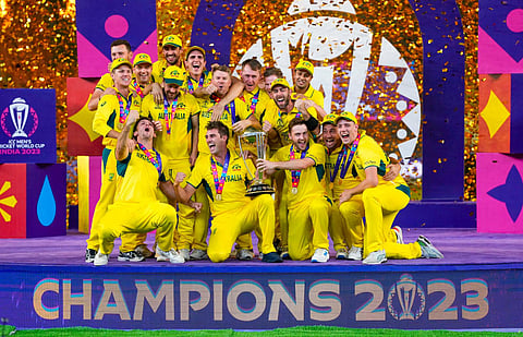 Australian players celebrate with the trophy after winning the ICC Mens Cricket World Cup 2023 finals at the Narendra Modi Stadium, in Ahmedabad, Sunday, Nov. 19, 2023. (Photo | PTI)