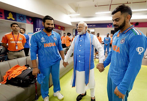 PM Narendra Modi with Indian captain Rohit Sharma and player Virat Kohli during a meeting with the team in the dressing room after the final in Ahmedabad, Sunday, Nov. 19, 2023. (Photo | PTI)