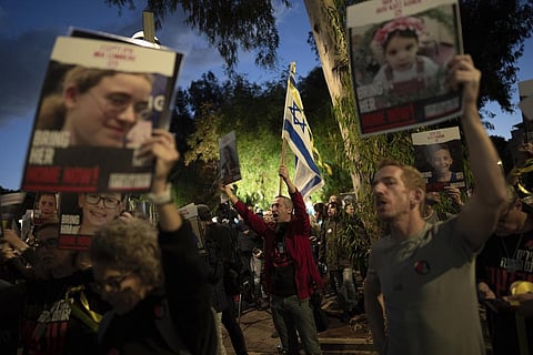 Demonstrators call for the return of 40 children who are among the roughly 240 hostages believed held by Hamas militants in the Gaza Strip in Tel Aviv on Nov 30, 2023. (AP)