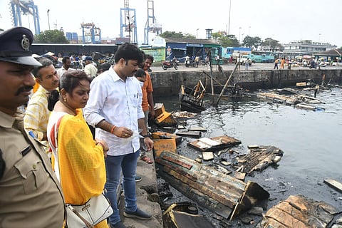 Forensic team collecting samples from the jetty at the fishing harbour in Visakhapatnam where a blaze destroyed over 35 boats. Express.