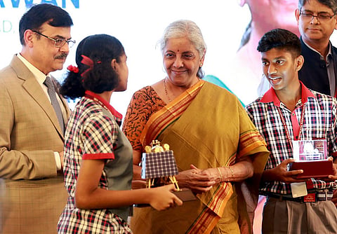 Union Finance Minister Nirmala Sitharaman presenting a model of Chandrayaan-3 to schoolchildren during the inauguration of Aayakar Bhawan in Kochi. (Photo | T P Sooraj)