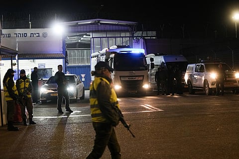 An Israeli prison transport vehicle carries Palestinian prisoners released by the Israeli authorities from Ofer military prison near Jerusalem on Friday, November 24, 2023. (Photo | AP)