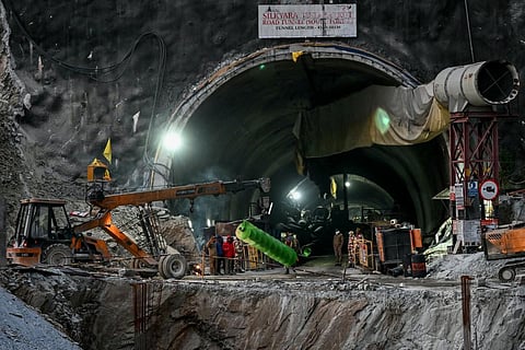 FILE - A crane carries a part of a drilling machine during rescue operations for workers trapped in the Silkyara under-construction road tunnel in Uttarkashi district, Nov 22, 2023.