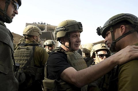 Israel's Netanyahu, centre, greets soldiers as he visits the Gaza Strip, where he received security briefings with commanders and soldiers. (Photo | AP)