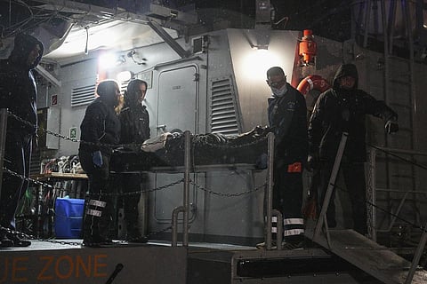 Paramedics carry the body of a crew member of a ship, on the northeastern Aegean Sea island of Lesbos, Greece. (Photo | AP)