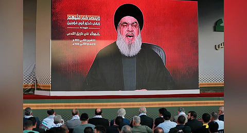 Supporters of the Lebanese Shiite movement Hezbollah watch a televised speech by its leader Hassan Nasrallah  in Beirut | AFP