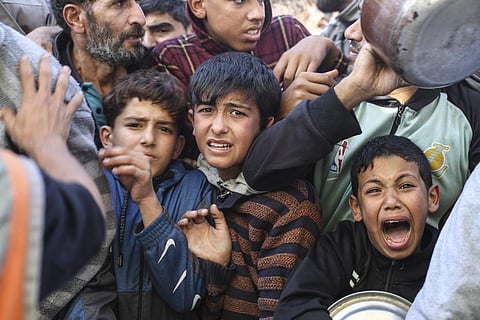 Palestinians line up for food in Rafah, Gaza Strip, Thursday, Nov. 30, 2023, during a temporary ceasefire between Israel and Hamas. (Photo | AP)