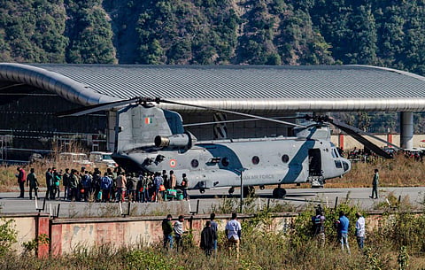 Rescued workers from the Silkyara Tunnel being airlifted to AIIMS Rishikesh aboard IAF's Chinook helicopter at the Chinyalisaur airstrip, in Uttarkashi, Nov. 29, 2023. (PTI Photo)