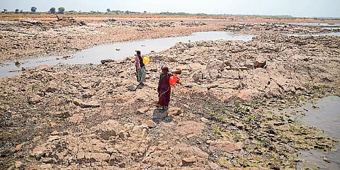 Women in N.Mallkapur walk for 15-20 mins to fetch water from the dried up river bed of Tungabharda river in Raichur district of Karnataka. (File Photo | Pushkar.V)
