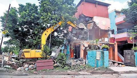 Water Resources Department began demolishing more than 700 houses allegedly built on encroached land at Anakaputhur along the Adyar on Saturday. (Photo | Martin Louis, EPS)