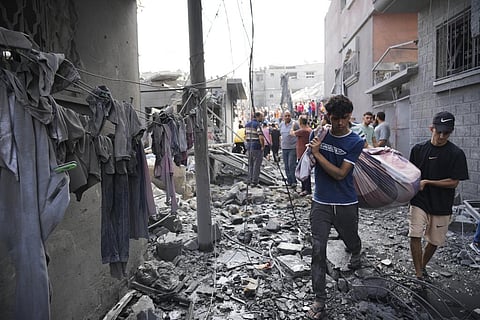 Palestinians carry a body after the Israeli bombardment in the Maghazi refugee camp in the Gaza Strip on Nov. 5, 2023. (AP)
