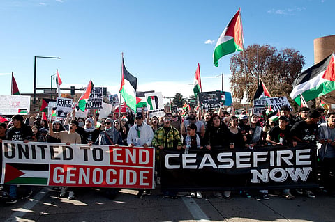 Demonstrators march down Colfax Avenue during a rally in support of Palestinians in Denver, Colorado, on November 5, 2023. (AFP)