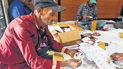 Employees of the GHMC’s Entomology department are seen packing voter IDs for deliveries at the GHMC head office in Hyderabad  | Vinay Madapu