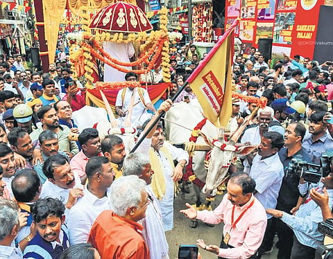 Deputy Chief Minister DK Shivakumar flags off a bullock cart procession at Chickpet in Bengaluru on Thursday  | express