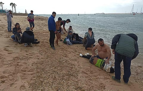 Migrants are rescued by locals on the shore of a beach , close to the southwestern city of Cádiz, Spain, Thursday, Nov 30, 2023. (Photo | AP)