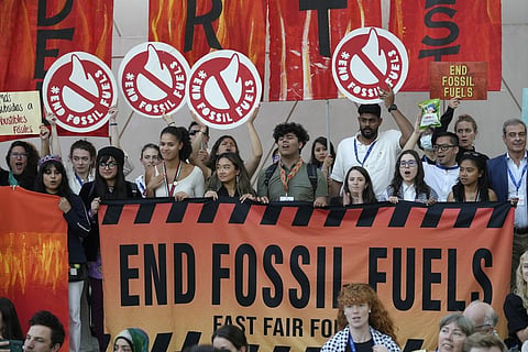 Activists participate in a demonstration against fossil fuels at the COP28 UN Climate Summit, Tuesday, Dec. 12, 2023, in Dubai, United Arab Emirates. (AP Photo)
