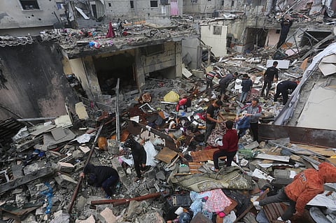 Palestinians salvage their belongings after an Israeli strike in Rafah, Gaza Strip, on Wednesday, December 13, 2023. (Photo | AP)