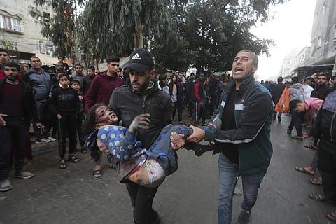 Palestinians evacuate survivors of the Israeli bombardment of the Gaza Strip in Rafah on Tuesday, Dec 12, 2023. (Photo | AP)