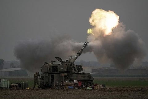 An Israeli mobile artillery unit fires a shell from southern Israel towards the Gaza Strip, in a position near the Israel-Gaza border on Thursday, Dec. 14, 2023. (AP Photo)