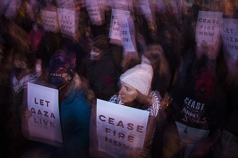 Demonstrators gather to shut down the Spring Garden Street Bridge during a Pro-Palestinian rally on Thursday, Dec. 14, 2023, in Philadelphia, USA. (AP Photo)