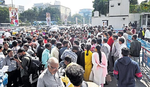 People wait outside Praja Bhavan to attend Prajavani in Hyderabad on Friday; (above) Hyderabad District Collector Anudeep Durishetty receives applications from  the people | Vinay Madapu