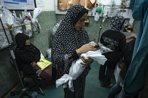 Palestinians mourn their relatives killed in the Israeli bombardment of the Gaza Strip, at the Hospital Rafah,  Dec 19, 2023. (Photo | AP)