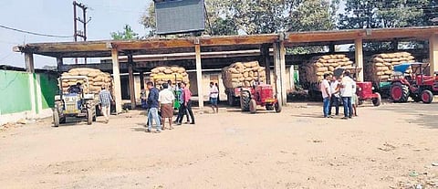 Farmers with their paddy stocks at the market yard. (Photo| Express)
