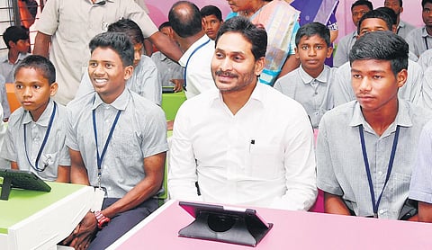 Chief Minister YS Jagan Mohan Reddy with government school students  at Chinturu in Alluri Sitarama Raju district on Thursday | Express