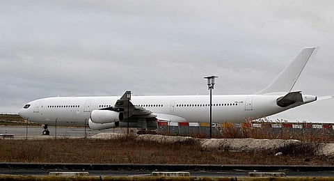 This photograph taken on December 23, 2023, shows the Airbus A340 which was grounded over suspected 'human trafficking' at Vatry airport, north-eastern France.  (AFP)