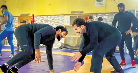 Rahul Gandhi with wrestler Bajrang Punia at Chhara, in Jhajjar on Wednesday  | pti