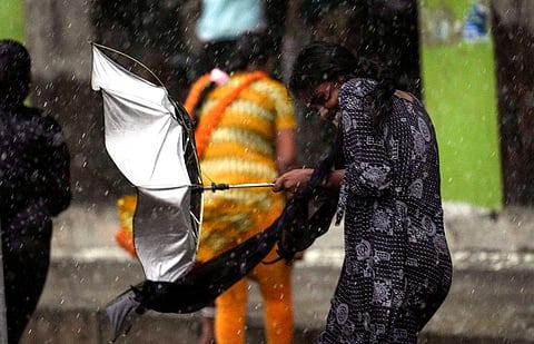 A pedestrian during heavy rain owing to Cyclone Michaung, in Chennai, Sunday, Dec. 3, 2023. (Photo | PTI)