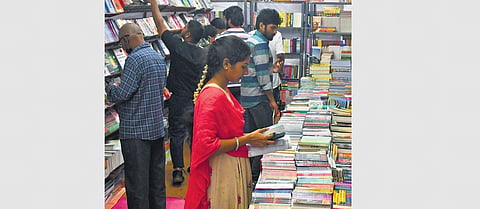 People taking a look at the books displayed at the 34th edition of Book Exhibition in Vijayawada on Friday I Prasant Madugula