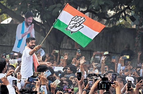 TPCC chief A Revanth Reddy waves the party flag at Gandhi Bhavan amidst a huge number of supporters in Hyderabad following the Telangana Assembly election results |  Sri Loganathan Velmurugan