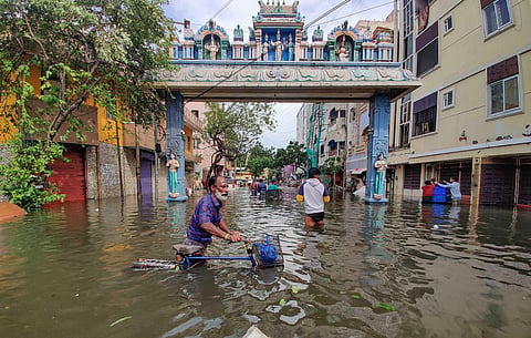 People wade through a flooded road after heavy rainfall owing to Cyclone Michaung, in Chennai, Tuesday, Dec. 5, 2023. (PTI)