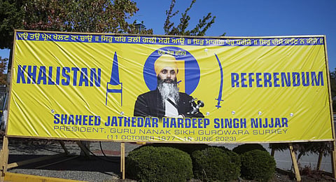 FILE: A photograph of Hardeep Singh Nijjar is seen on a banner outside the Guru Nanak Sikh Gurdwara Sahib in Canada's Surrey. (Photo | AP)