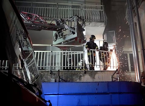 Firefighters work on the balcony of a building of the San Giovanni Evangelista Hospital after a fire broke out causing the death of four people in Tivoli, Italy on Friday, Dec 8, 2023. (Photo | AP)