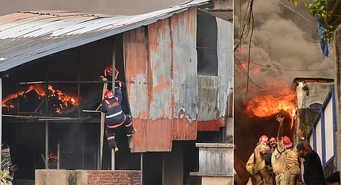 Fire and Rescue Services personnel dousing the fire at the aquarium godown near Vazhuthacaud in Thiruvananthapuram. (Photo | B P Deepu, EPS)
