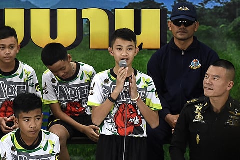In this file photo taken on July 18, 2018, Duangpetch Promthep (C) speaks during a press conference in Chiang Rai following his team's discharge from hospital. (File Photo | AFP)