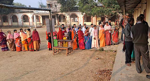 Voters standing in a queue to cast their votes at a polling booth under Bamutia Assembly segment near Agartala on Thursday. (Photo | EPS)
