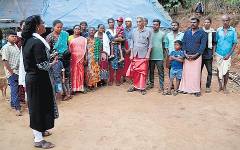 In this representational image, Adivasi Gothra Maha Sabha leader C K Janu interacts with community members at Pulimoodukunnu colony near Mananthavady. (Photo | T P Sooraj) 