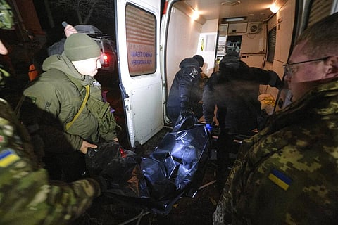 Police officers carry a body which was killed by a Russian rocket attack at residential neighbourhood in Kramatorsk, Ukraine, on Thursday. (Photo | AP)