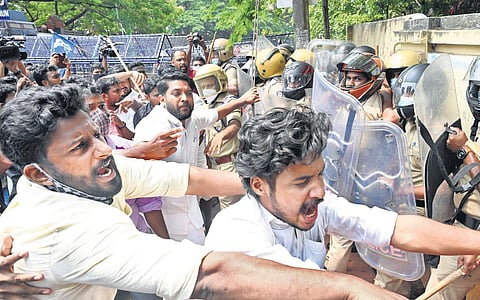In this file image, MLA Shafi Parambil tries to prevent Youth Congress workers from attacking the police during their protest march on February 15, 2023. (Photo | EPS, Vincent Pulickal)