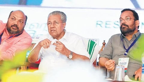 Pinarayi Vijayan and P Rajeeve share a light moment during the inauguration of mega entrepreneurs meet in Kochi on Saturday. Revenue Minister K Rajan is also seen | T P Sooraj