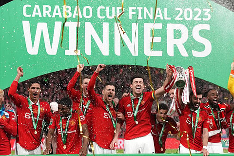 Manchester United's players celebrate with the trophy after winning the English League Cup final at Wembley Stadium in London, Feb. 26, 2023. (Photo | AP) 