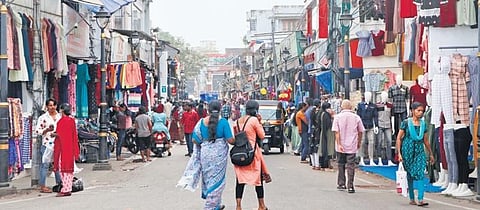 A busy street at Pazhavangadi where the walkways have been encroached by vehicles and traders