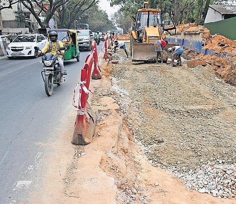Traffic moves on Ballari Road, where workers continue with the road-widening work, in Bengaluru on Friday | Vinod kumar T