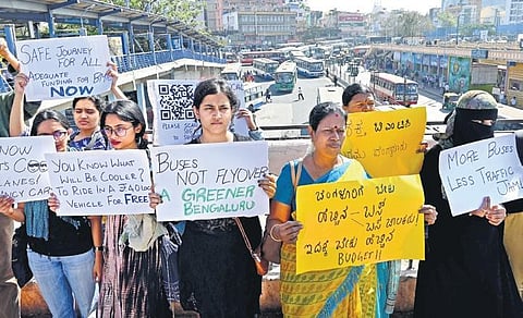 Volunteers of Bus Prayanikara Vedike hold placards of a campaign ‘Better BMTC for Better Bengaluru’, at Majestic Bus Stand in Bengaluru on Saturday |  Shashidhar Byrappa