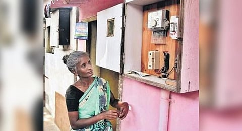 A woman checking the EB meter reading at her house in Madurai 